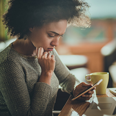 young woman on phone researching or thinking